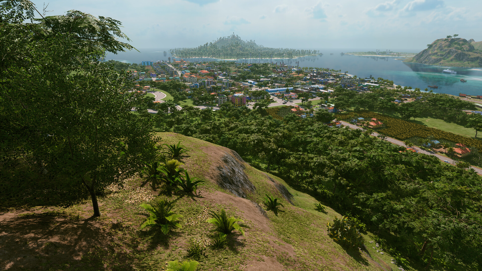 Captura oficial de Tropico 7 con una ciudad extendida entre montañas, costa e islas